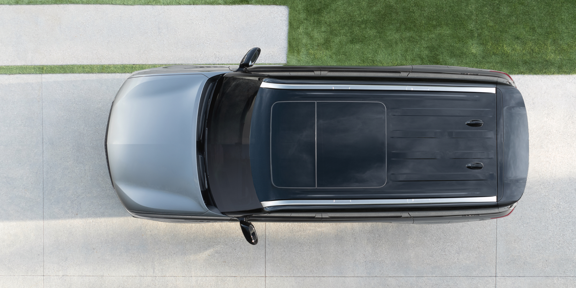 Overhead view of a 2027 INFINITI QX80 highlighting its panoramic glass roof, roof rails, and black two-tone body.