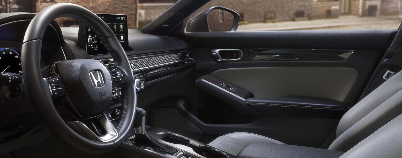 Black interior and dash are shown in a 2025 Honda Civic Hybrid