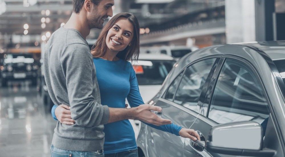 Couple at an auto dealer