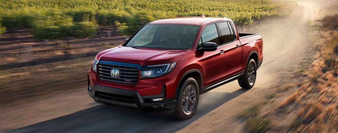 Red 2025 Honda Ridgeline driving off-road