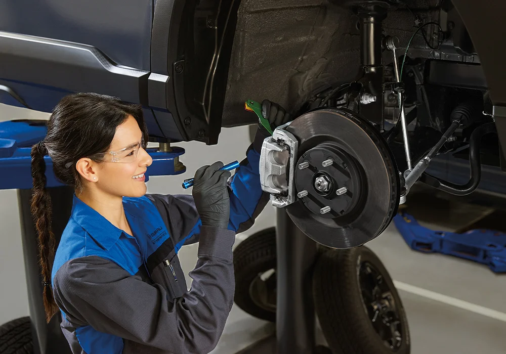 Subaru Tech working on a car