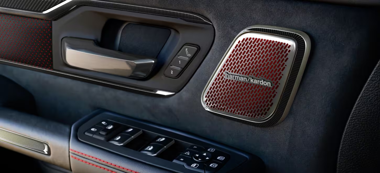 Harman Kardon speaker and red-stitched door panel inside the 2027 Ram 1500 TRX SRT