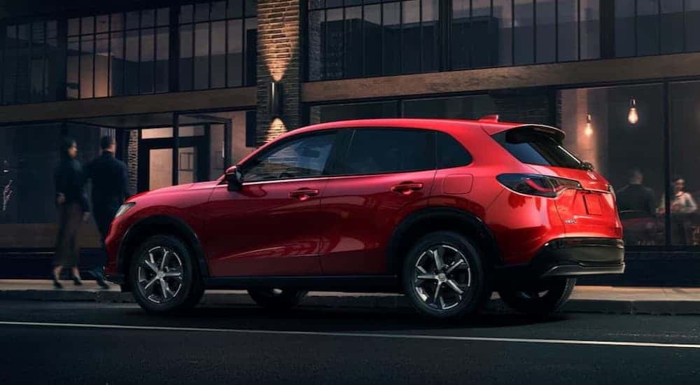 A red 2025 Honda HR-X EX-L parked in a city.