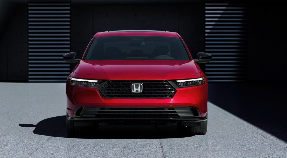 A red 2026 Honda Accord Sport-L Hybrid parked head-on.