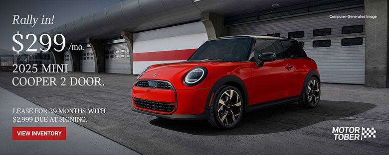 Front side view of MINI Cooper 2 Door parked in front of a garage