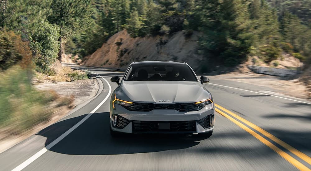  Grey Kia K5 for sale driving on a highway