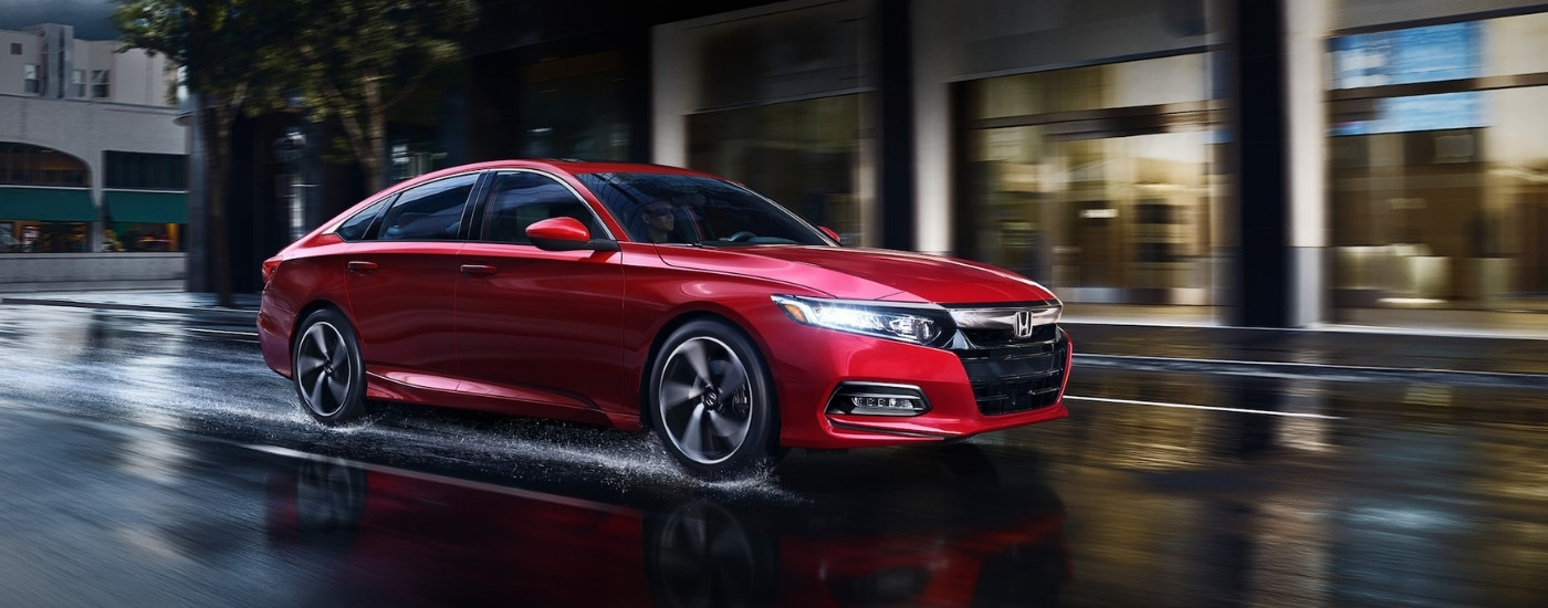 Red 2020 Honda Accord Sport driving in the rain at night