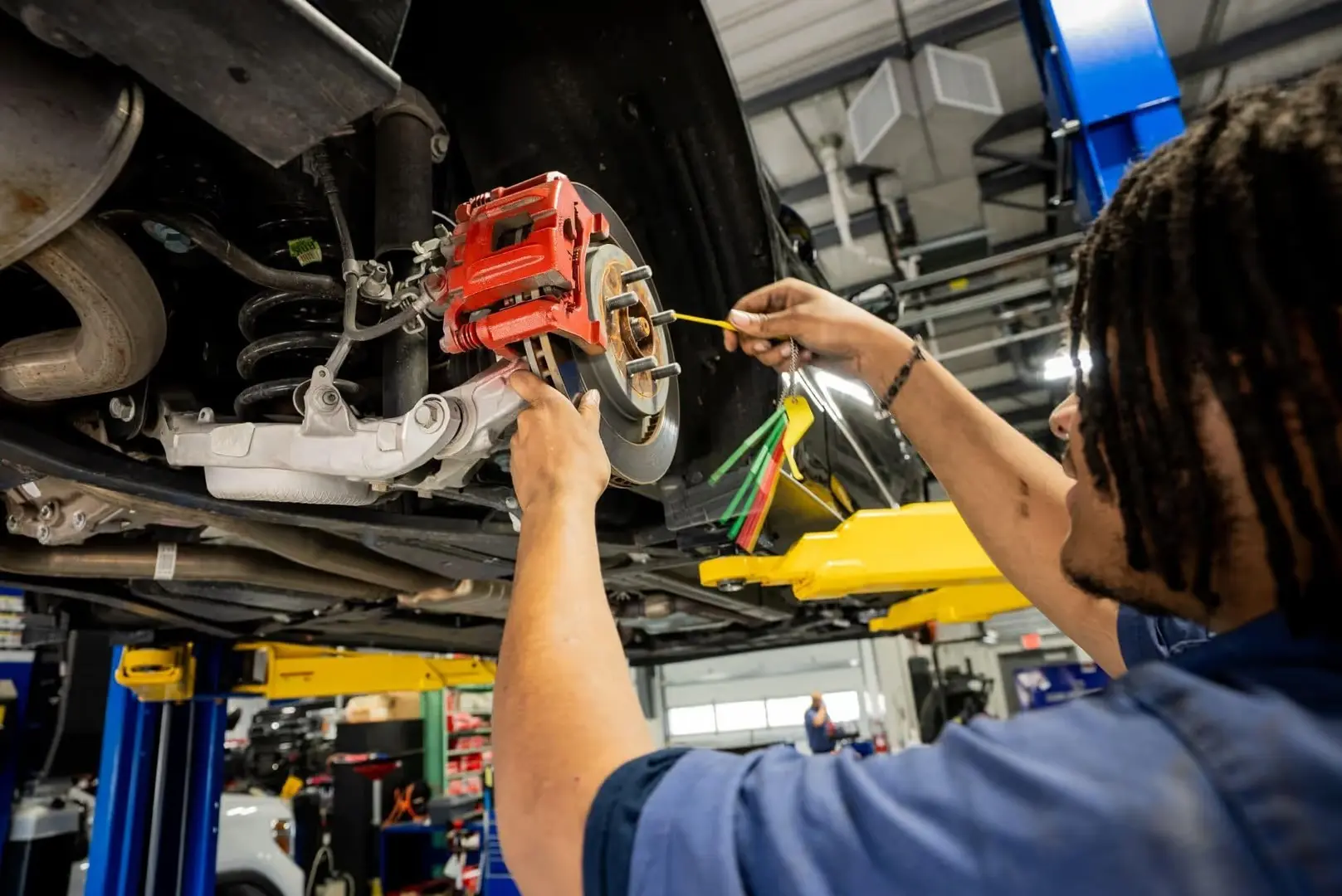 Automotive technician at Don Hattan Dealerships repairing brakes on a customer's vehicle.