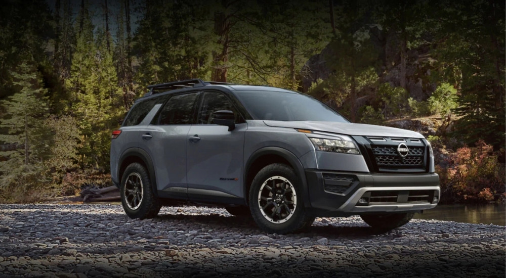 Grey 2025 Nissan Pathfinder Rock Creek for sale in Brooklyn Park parked off-road on a riverbed
