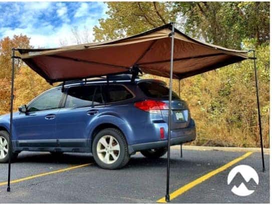 Blue Subaru Outback with a vehicle-mounted awning