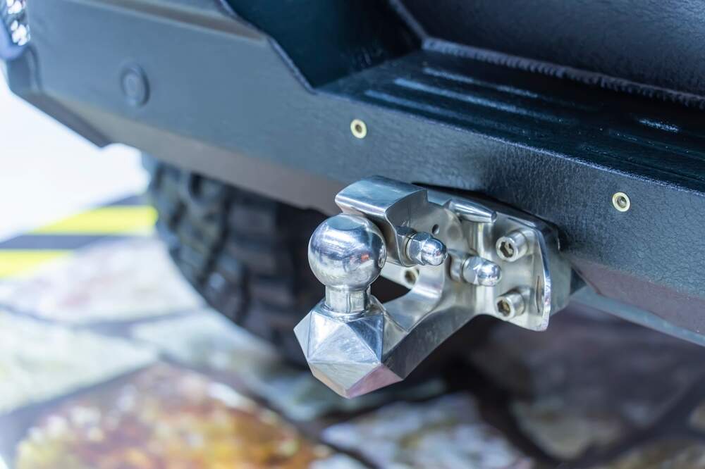 Trailer hitch on the back of a pickup truck.