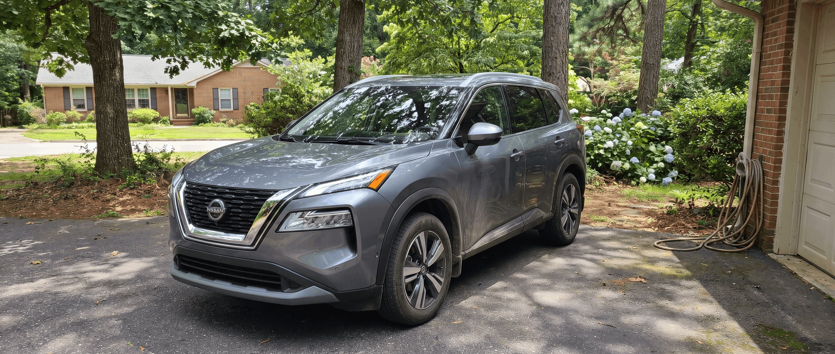 2022 Nissan Rogue third-generation compact SUV parked in Roswell Georgia suburban driveway