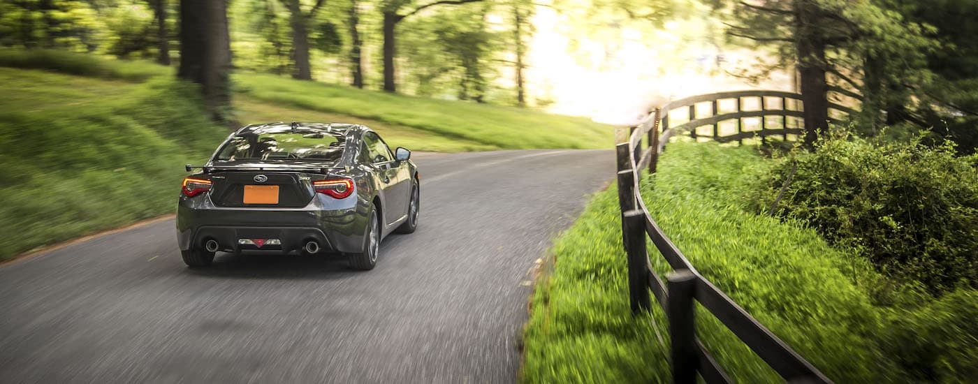 Grey 2019 Subaru BRZ Limited is shown driving past a fence