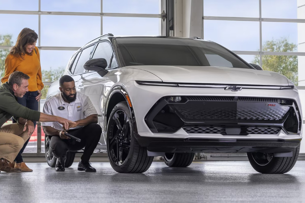 2024 Chevy Vehicle with Customers and Tech Discussing Tires