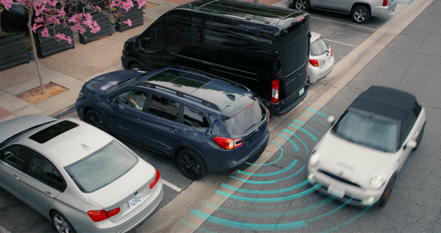 A Subaru projects an arcing line representing the Rear Cross-Traffic Alert.
