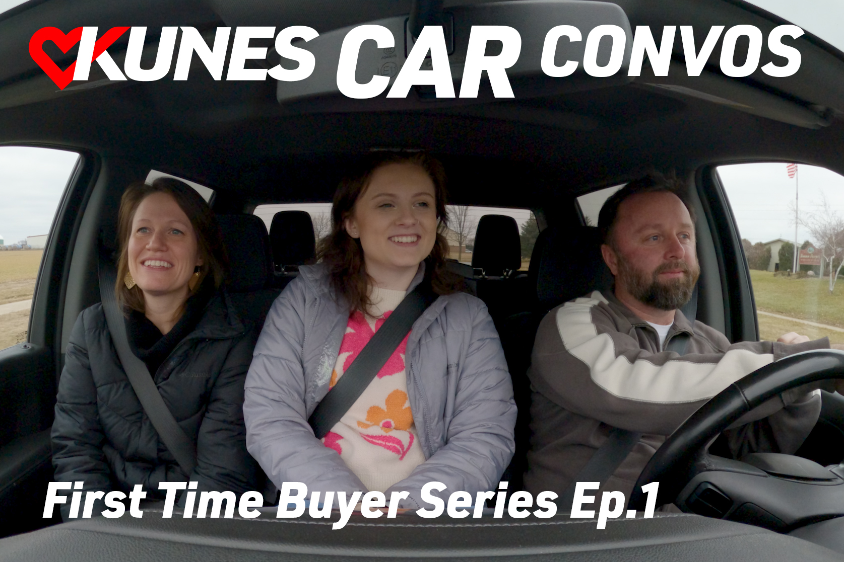 Text reads: Kunes Car Convos; Mike Kramp CEO of Geneva Lakes YMCA
Photo: Mike Kramp, CEO of Geneva Lakes YMCA, and Jen Myers, Marketing Director of Kunes Auto & RV Group, smile at each other while driving in a 2023 Grand Cherokee 4XE