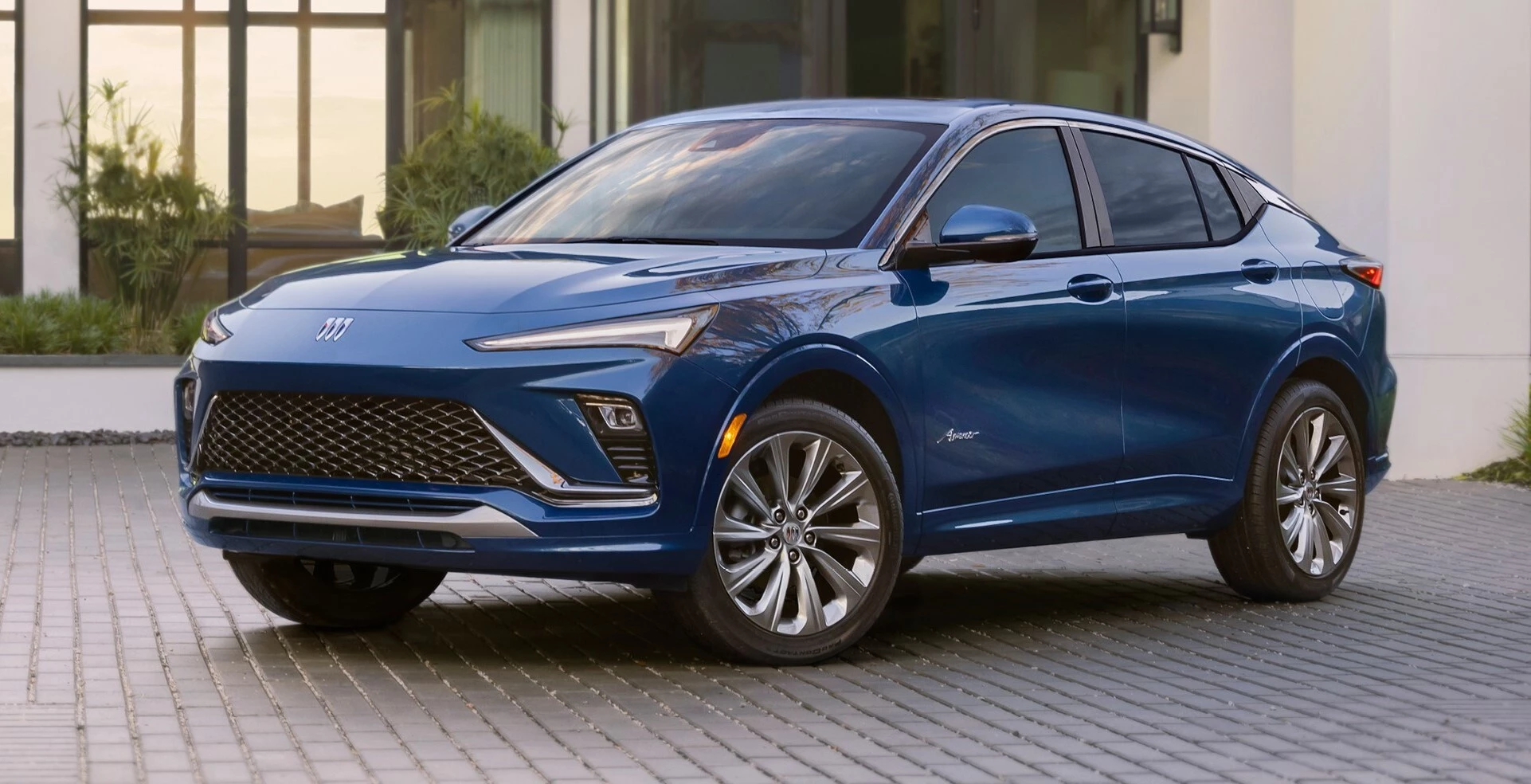 A Blue 2024 Buick Envista, The Car is set in front of a house and the vehicle is on brick tiles