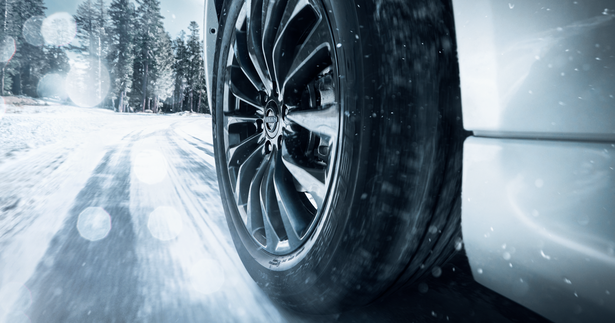 Nissan car driving on a winter road