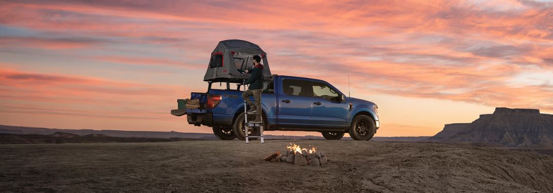 Blue 2024 Ford F-150 STX FX4 in Desert at Sunset with Rooftop Tent