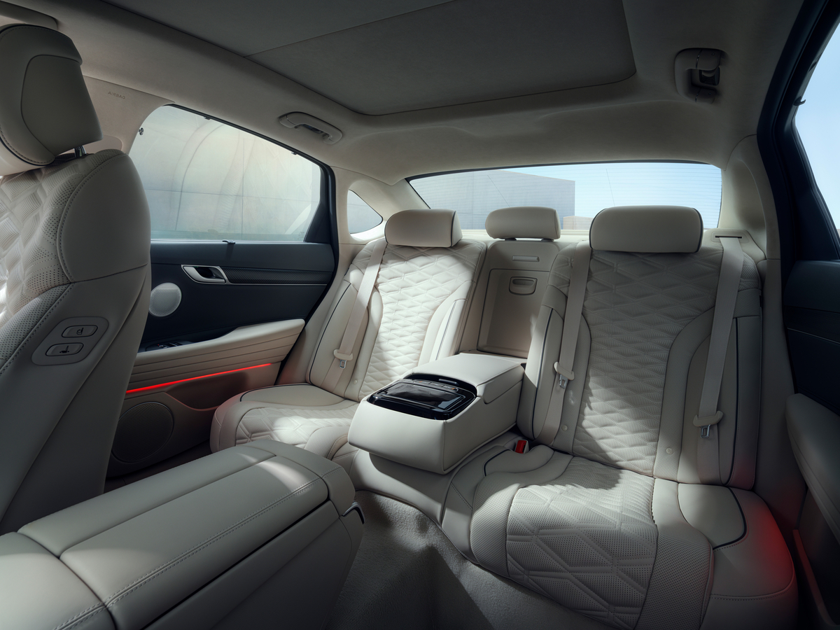 Interior driver seat pov of rear seating in Urban Brown / Glacier White inside the Genesis G80