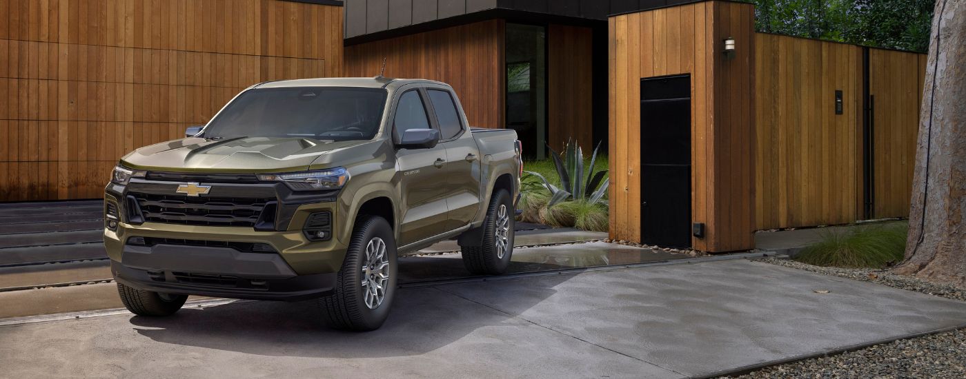 Brown 2023 Chevy Colorado parked in front of a building.
