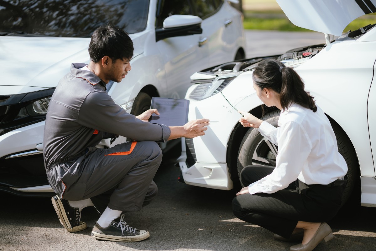 Insurance Adjuster Analyzes Automobile Damage