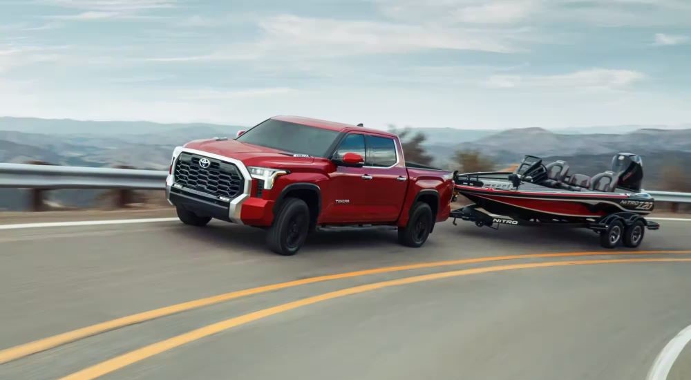 Red 2024 Toyota Tundra towing a fishing boat