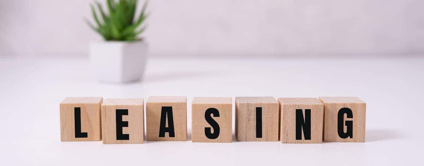 A row of wooden blocks is shown that spells out 'leasing.'