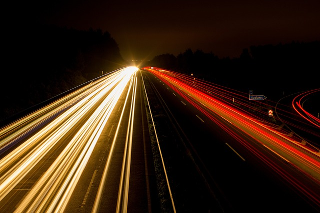 Highway With Headlights on left side and taillights on other side