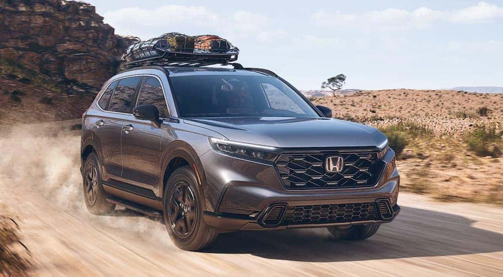 Grey 2023 Honda CR-V Sport Hybrid driving off-road