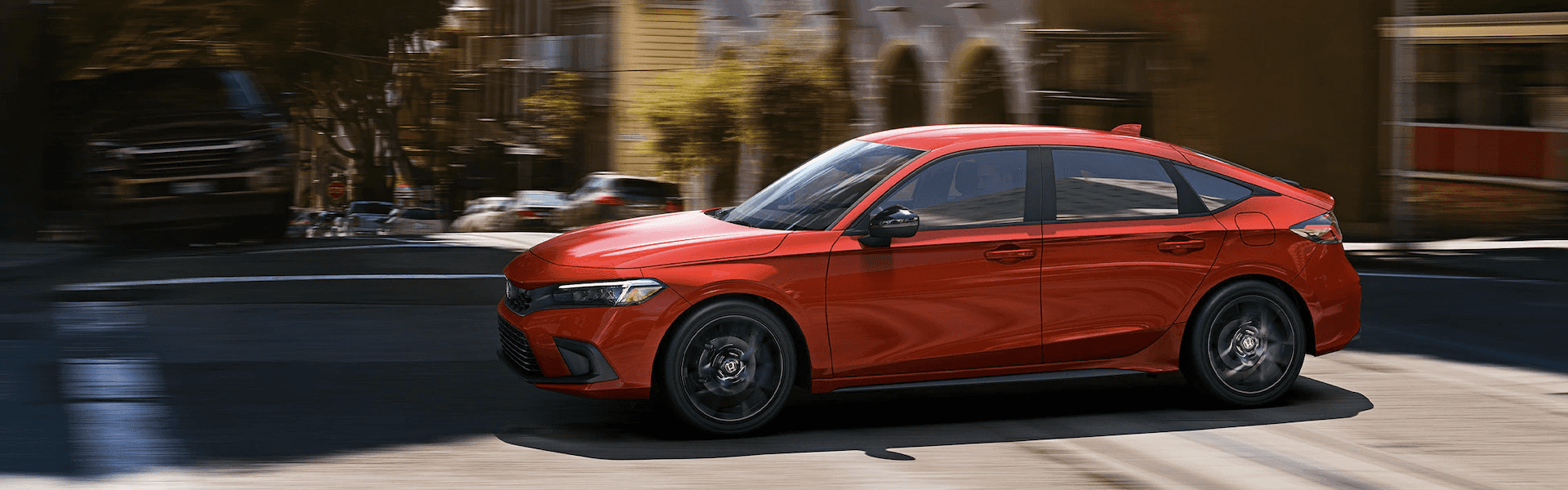 2024 Civic Hatchback in red running on city street