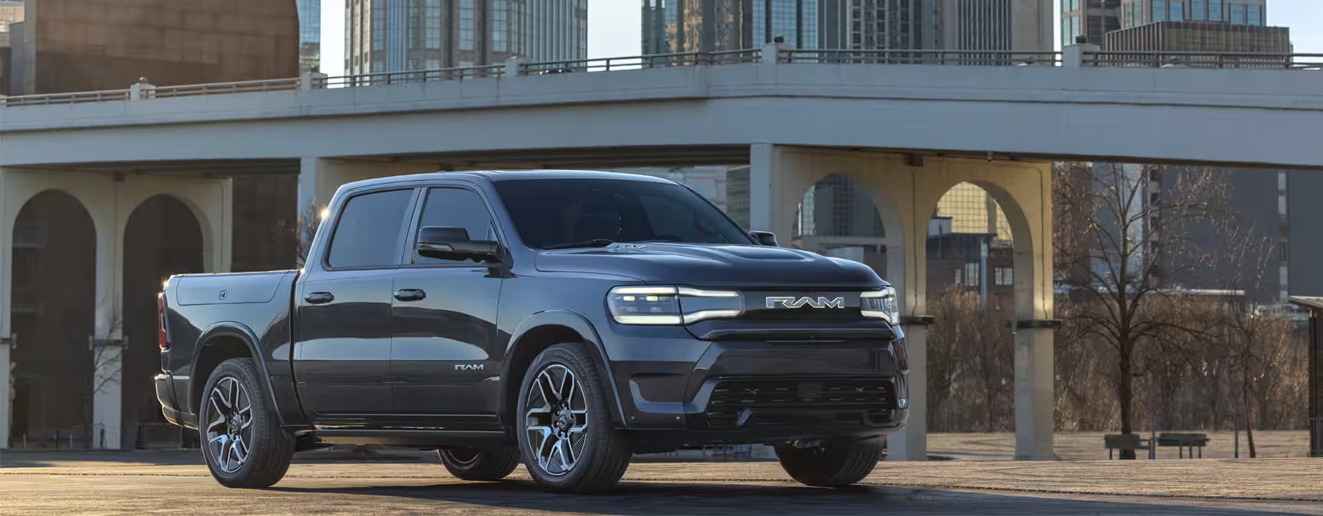 2024 Ram 1500 parked under an urban bridge, showcasing its bold design and modern features