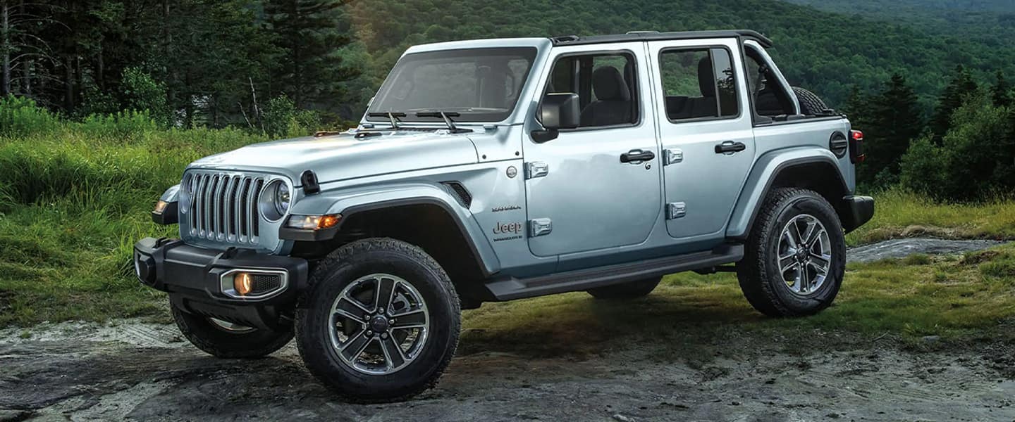 A silver jeep sitting parked.