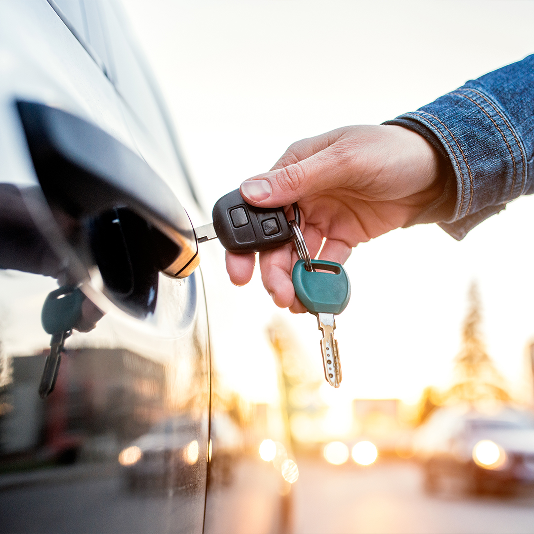 Hand inserting keys into car door