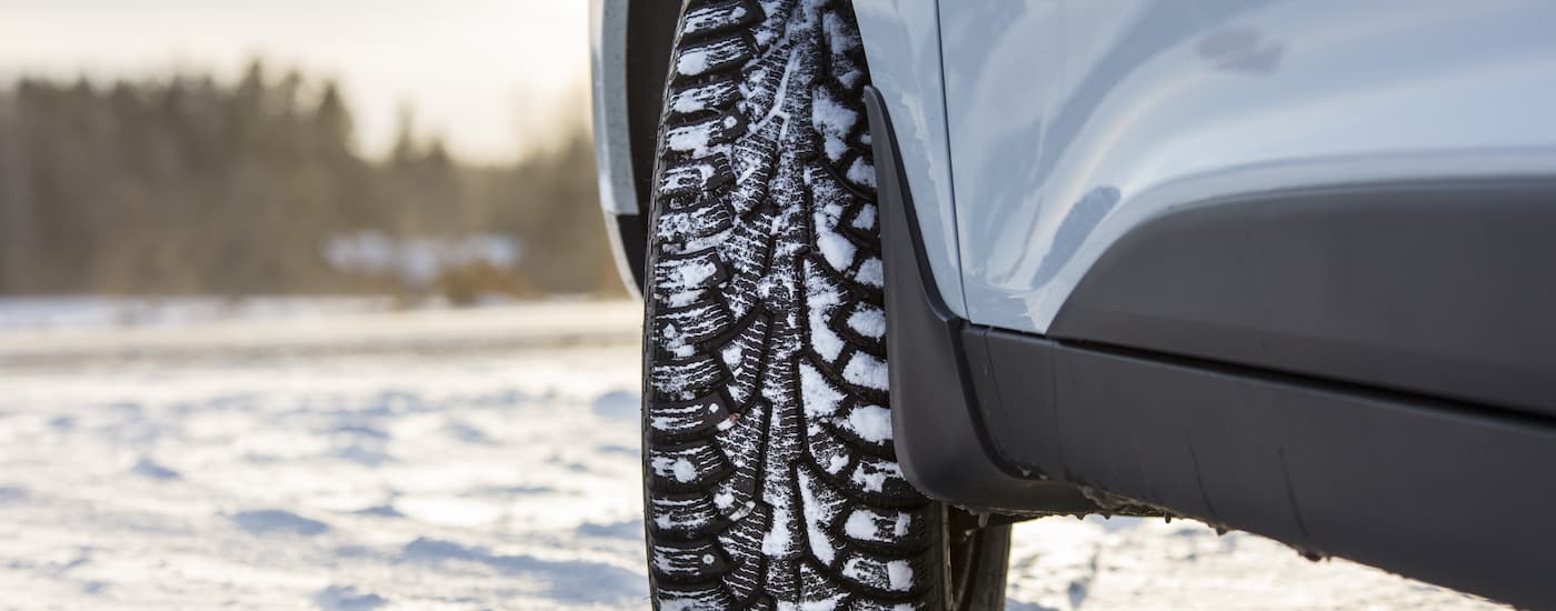 A close up of a snow covered winter tire in Rochester, NY is shown.