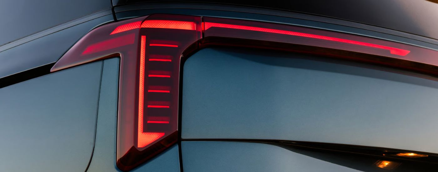 The LED taillight on a blue 2026 Kia Carnival.