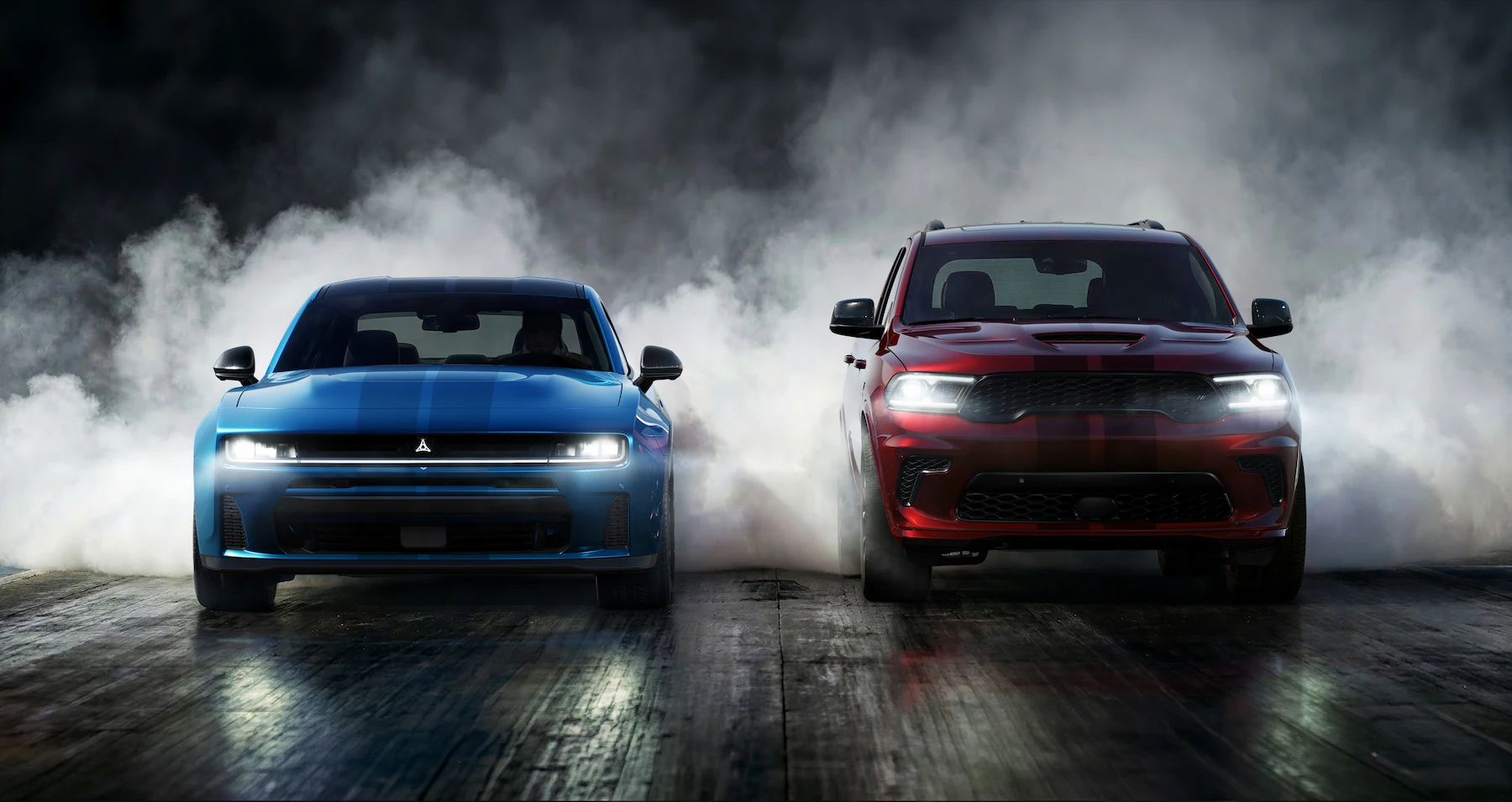 Dodge Charger and Durango in a burnout, showcasing performance featured in Victory's Certified Pre-Owned inventory
