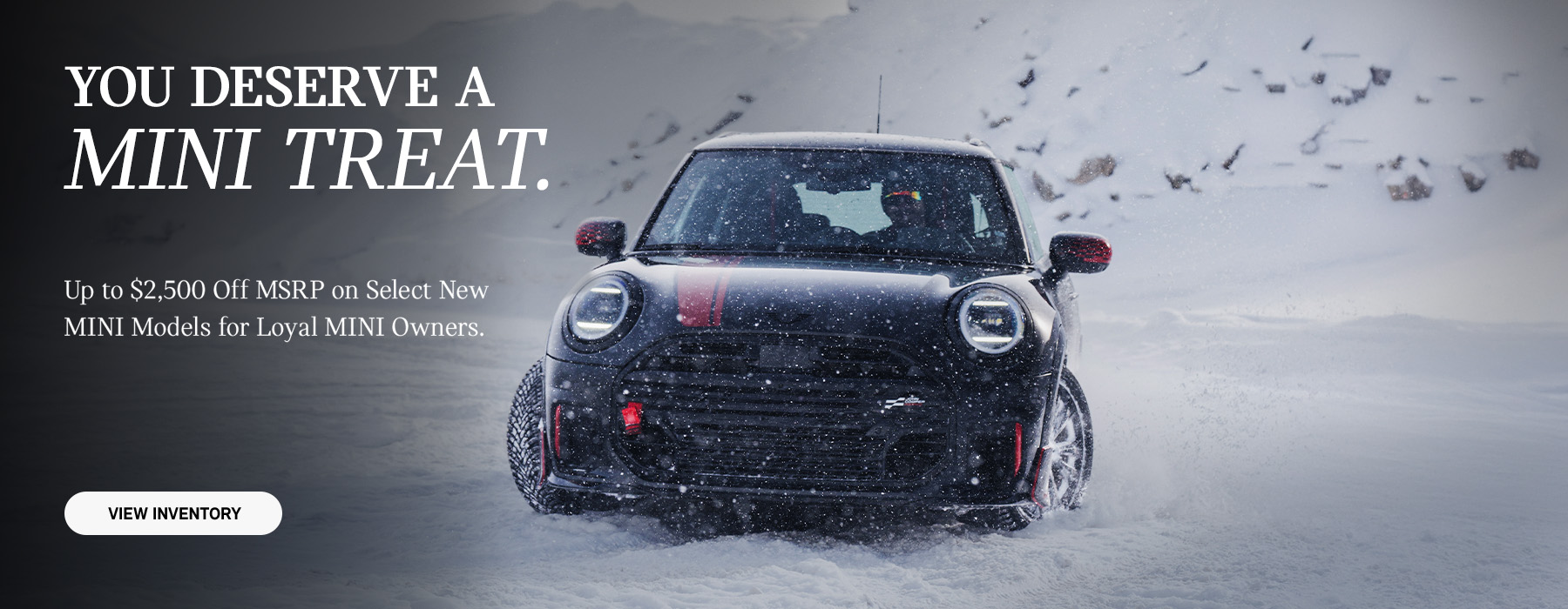 Front View of MINI JCW driving through the snow.
