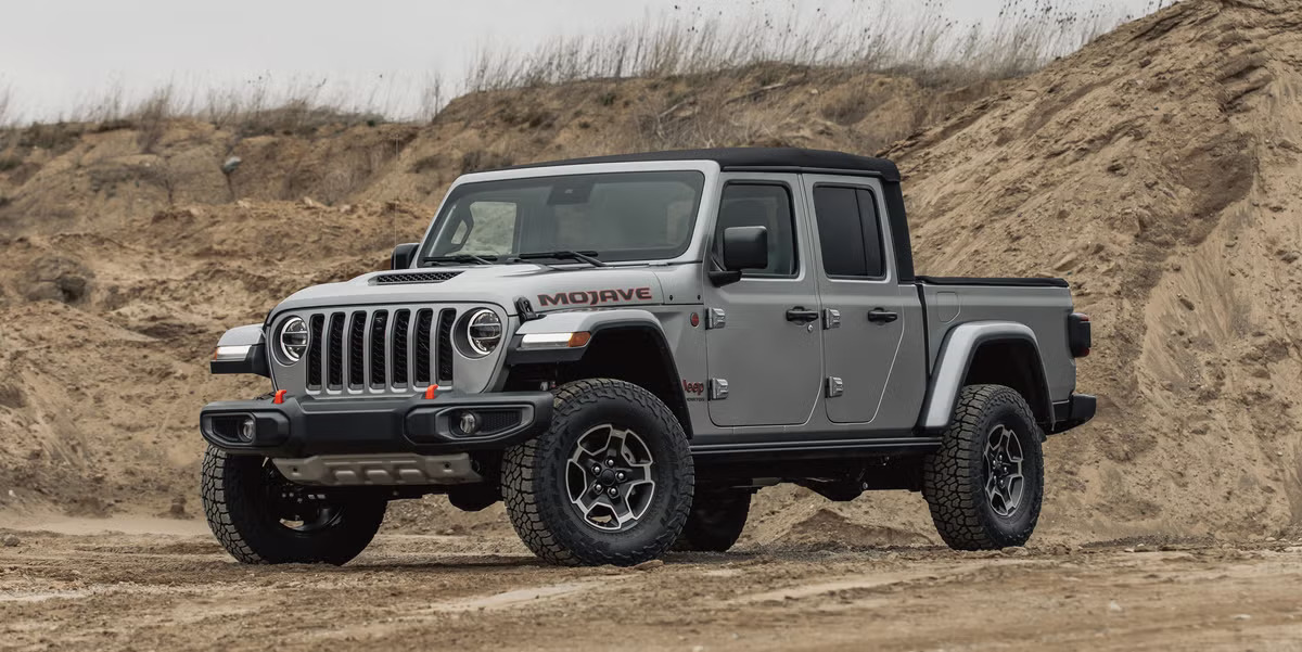 A gray 2022 Jeep Gladiatorparked on a dirt road.