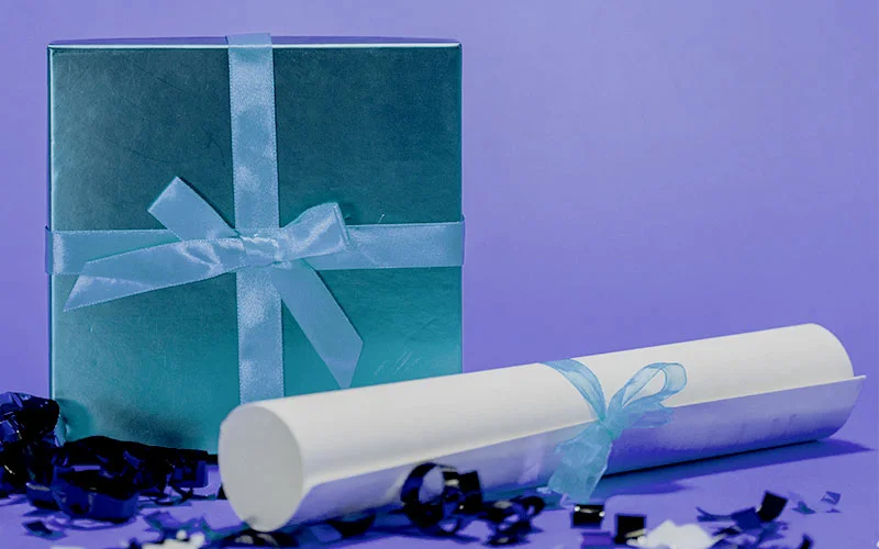 image of blue present box and certificate with blue bows