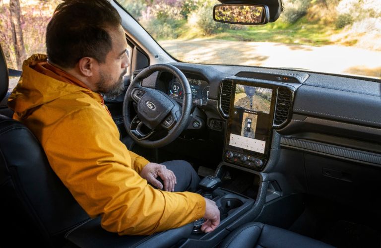 Man in Driver's Seat of 2024 Ford Ranger Using Trailer Backup Camera