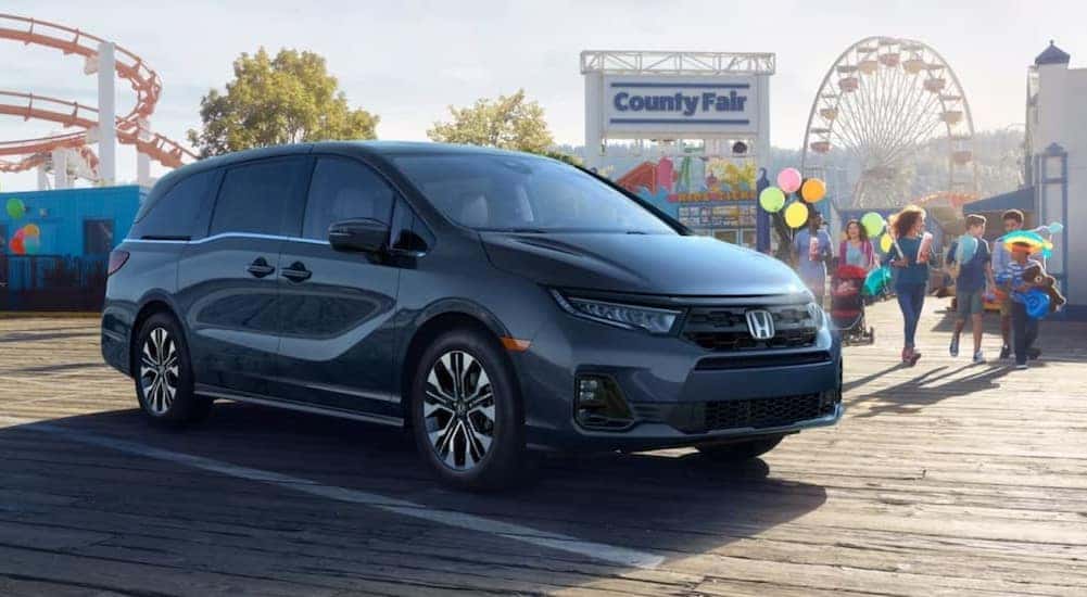 A black 2026 Honda Odyssey parked near a fair.