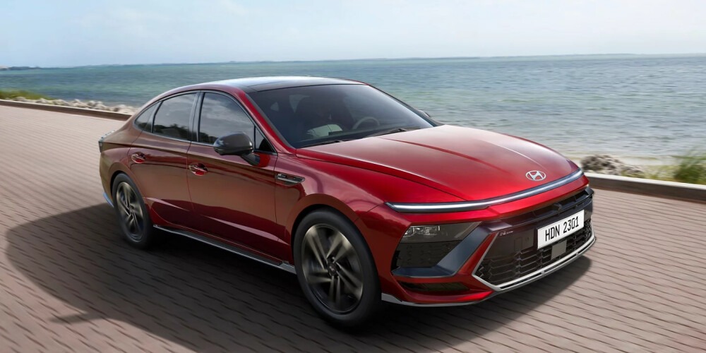 Red 2024 Hyundai Sonata parked on a seaside promenade