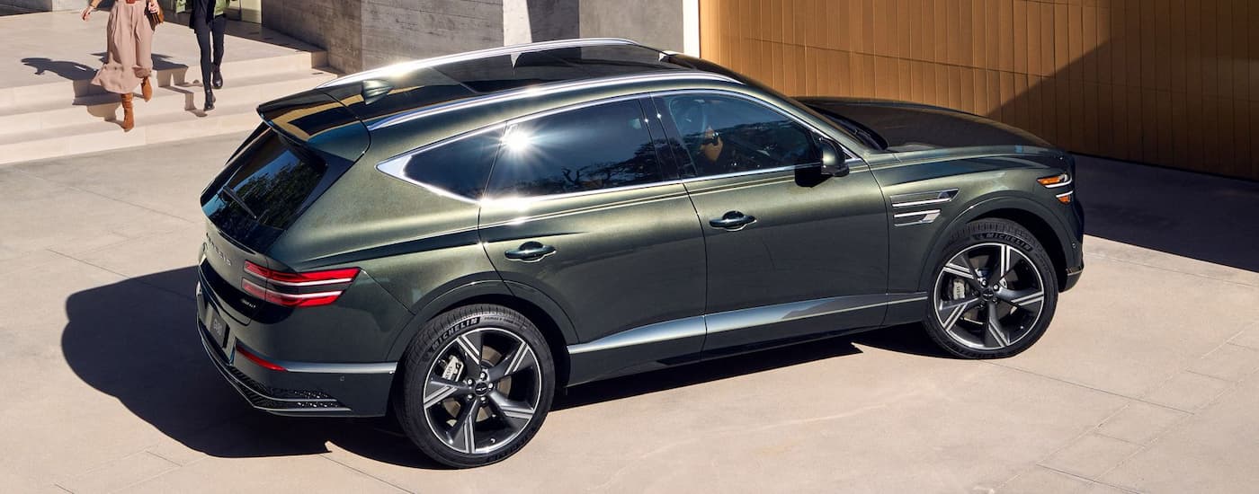 A green 2025 Genesis GV80 parked in a driveway