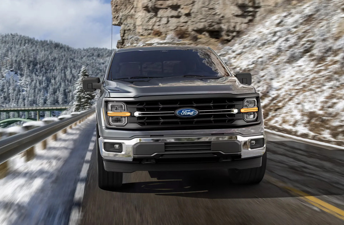 Front hero view of a Ford F-150 XLT driving on a road