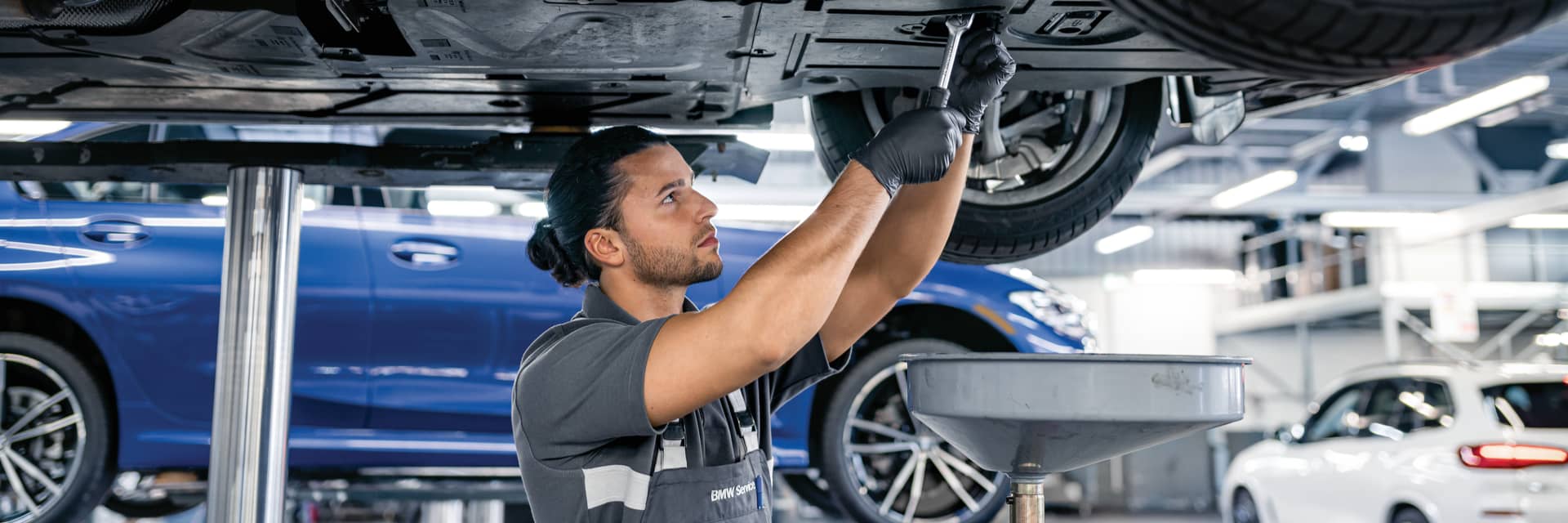 Service technician working on the underside of a vehicle