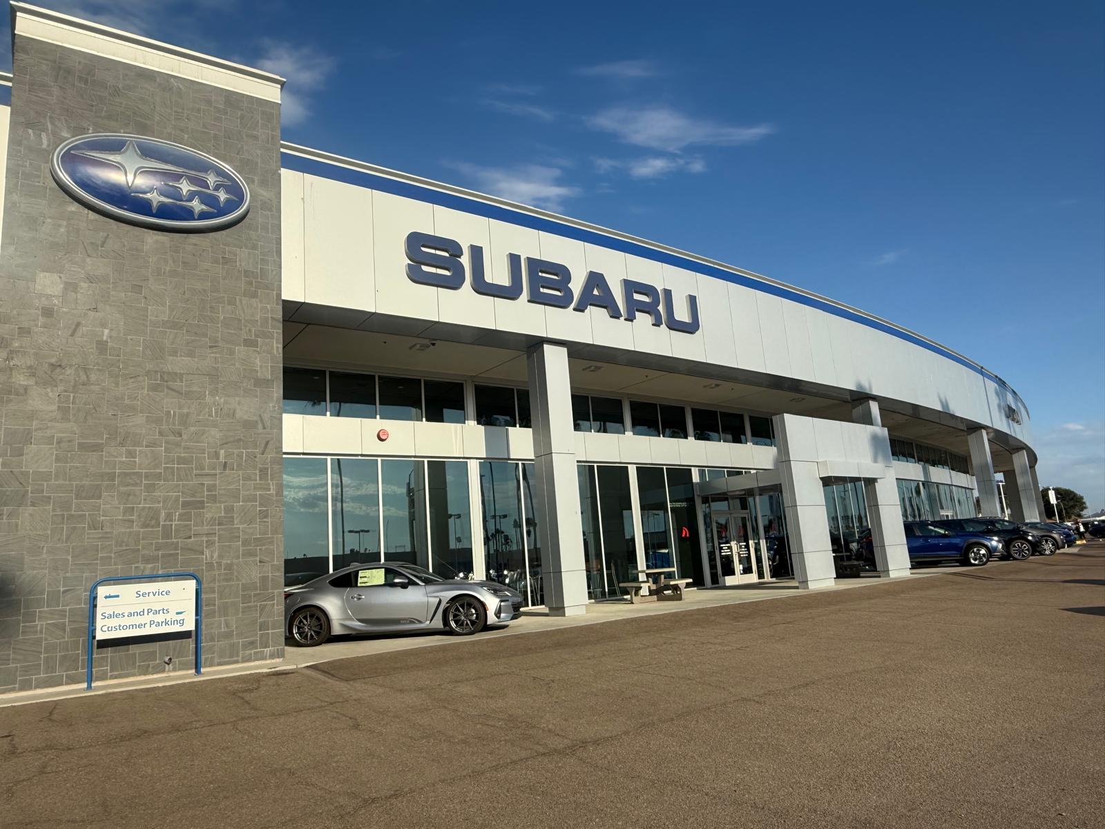 Exterior of the Dalton Subaru National City dealership with a red Subaru WRX out front
