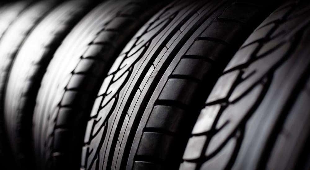 A close-up of a row of stacked tires is shown.