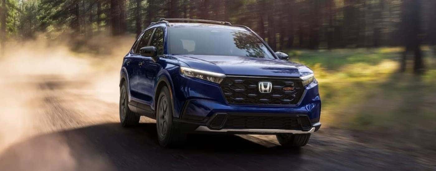 A blue 2026 Honda CR-V TrailSport Hybrid off-roading.