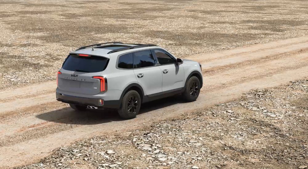 Grey 2025 Kia Telluride SX Prestige X-Pro driving on a dirt road